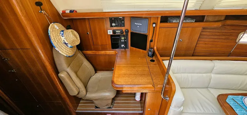 Momentum Yacht Photos Pics Interior of 2007 Hunter 45 Center Cockpit yacht with navigation station and seating area.