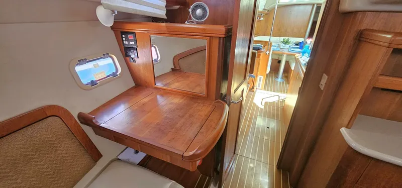 Momentum Yacht Photos Pics Interior of 2007 Hunter 45 Center Cockpit yacht with wooden desk and seating area.