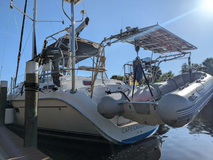 Momentum Yacht Photos Pics Hunter 45 Center Cockpit 2007 sailboat docked with dinghy and solar panels.