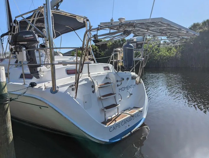 Momentum Yacht Photos Pics 2007 Hunter 45 Center Cockpit sailboat docked, featuring solar panels and Yamaha motor.