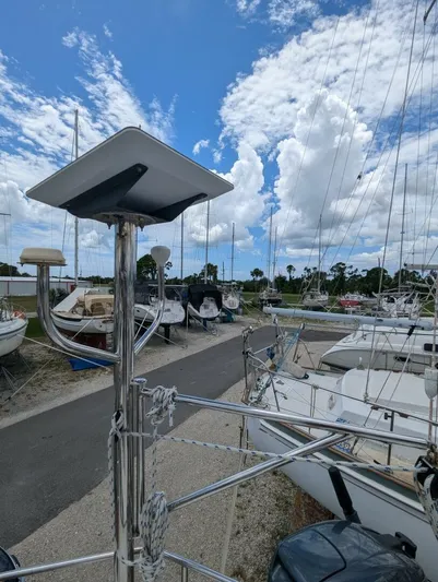 Momentum Yacht Photos Pics Sailboats docked at a marina under a partly cloudy sky, featuring a 2007 Hunter 45 Center Cockpit.