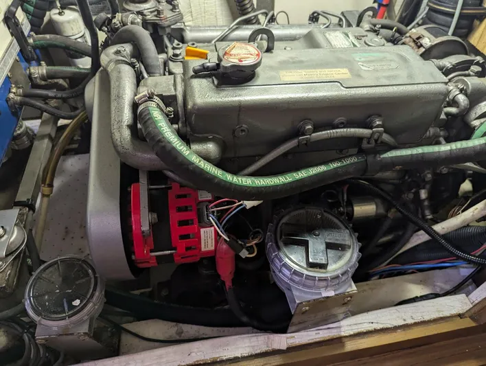 Momentum Yacht Photos Pics Engine compartment of a 2007 Hunter 45 Center Cockpit sailboat, showing detailed components and hoses.