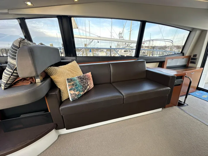  Yacht Photos Pics Interior of 2015 Prestige 500 S yacht with leather sofa and decorative pillows.