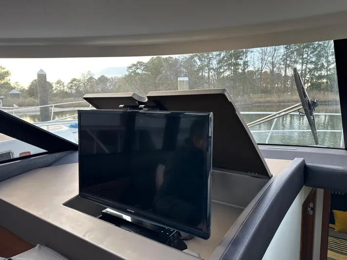  Yacht Photos Pics Interior of 2015 Prestige 500 S yacht with a mounted TV screen.