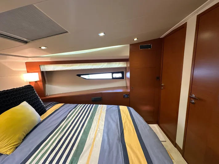  Yacht Photos Pics Luxurious bedroom interior of 2015 Prestige 500 S yacht with striped bedding and modern design.