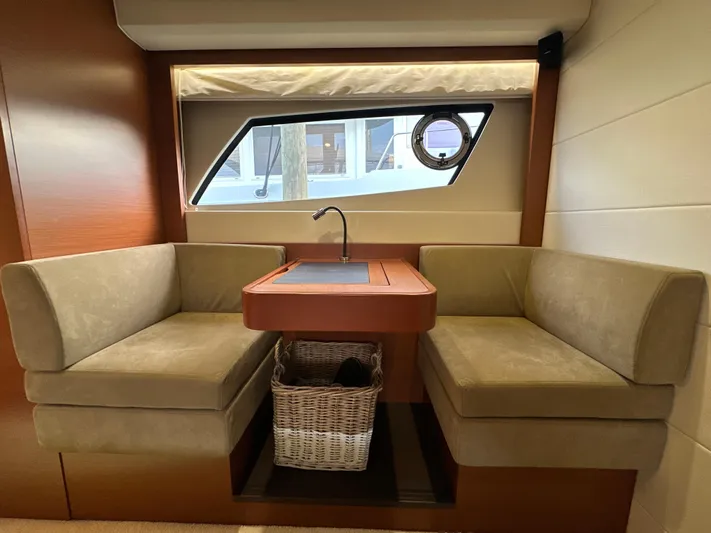  Yacht Photos Pics Interior of 2015 Prestige 500 S yacht with cozy seating and window view.