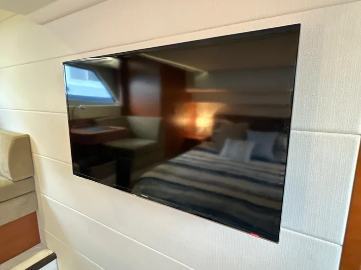  Yacht Photos Pics Flat-screen TV in 2015 Prestige 500 S yacht interior, with cozy bedroom and seating area.