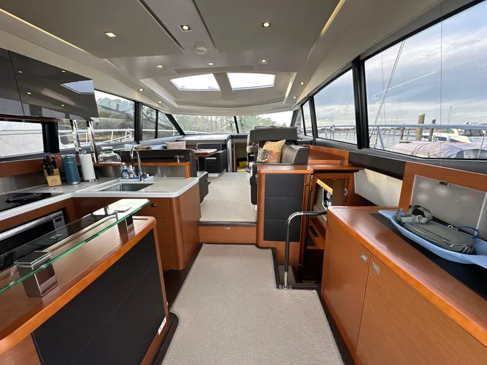  Yacht Photos Pics Luxurious interior of a 2015 Prestige 500 S yacht with modern kitchen and seating area.