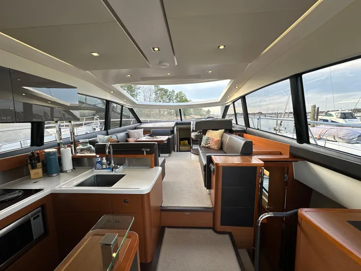  Yacht Photos Pics Luxurious interior of a 2015 Prestige 500 S yacht with modern amenities and panoramic windows.