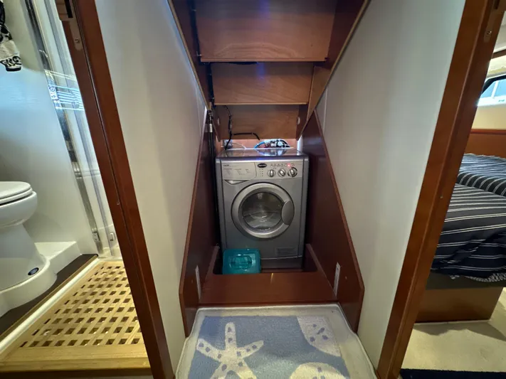  Yacht Photos Pics Laundry area with washing machine in 2015 Prestige 500 S yacht interior.