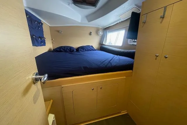 Buzio Yacht Photos Pics Cozy cabin interior of 2014 Lagoon 380 S2 catamaran with double bed and storage.