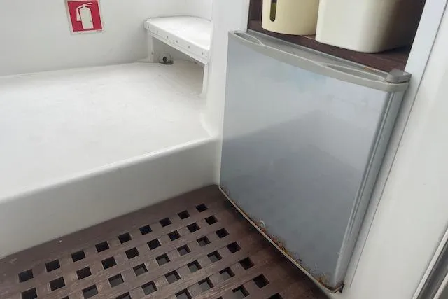 Buzio Yacht Photos Pics 2014 Lagoon 380 S2 yacht interior with fridge and fire extinguisher sign.