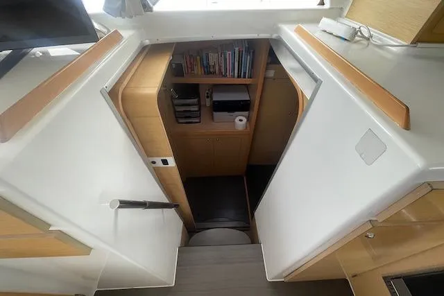 Buzio Yacht Photos Pics Interior of 2014 Lagoon 380 S2 yacht with wooden cabinetry and bookshelves.