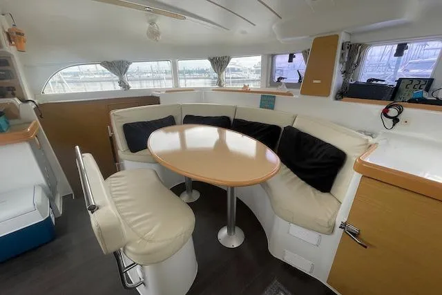 Buzio Yacht Photos Pics Interior of 2014 Lagoon 380 S2 catamaran with cozy seating and dining area.