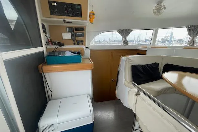 Buzio Yacht Photos Pics Interior of 2014 Lagoon 380 S2 catamaran with seating area and navigation equipment.