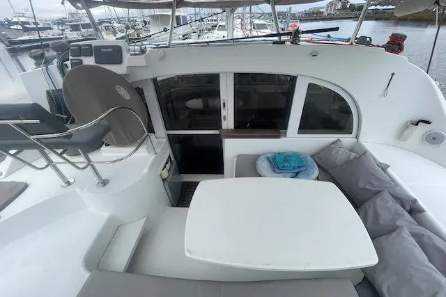 Buzio Yacht Photos Pics 2014 Lagoon 380 S2 yacht cockpit with seating and table, docked at marina.
