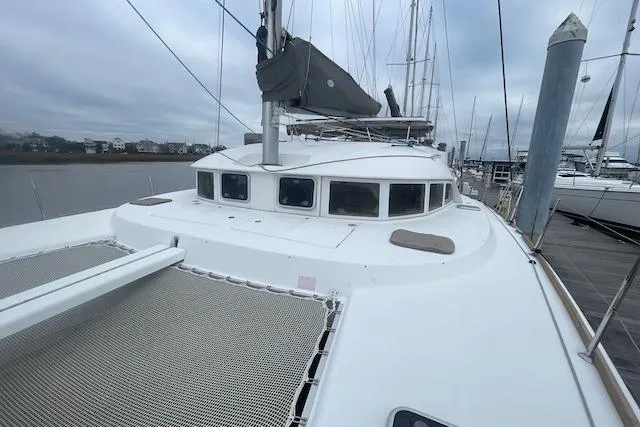 Buzio Yacht Photos Pics 2014 Lagoon 380 S2 catamaran docked at marina, overcast sky.