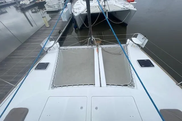 Buzio Yacht Photos Pics 2014 Lagoon 380 S2 catamaran docked, featuring spacious deck and netting.