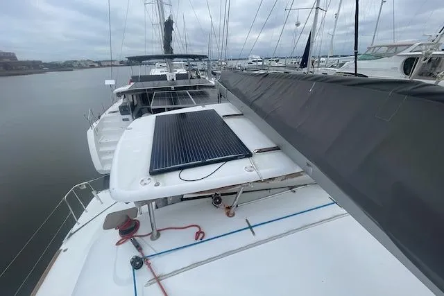 Buzio Yacht Photos Pics 2014 Lagoon 380 S2 catamaran with solar panel, docked in a marina.