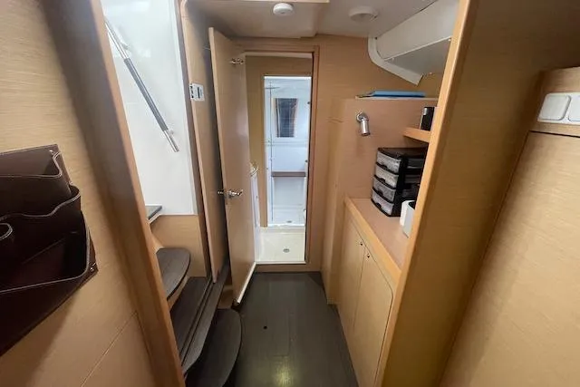 Buzio Yacht Photos Pics Interior of 2014 Lagoon 380 S2 yacht, featuring a compact hallway with wooden cabinetry.