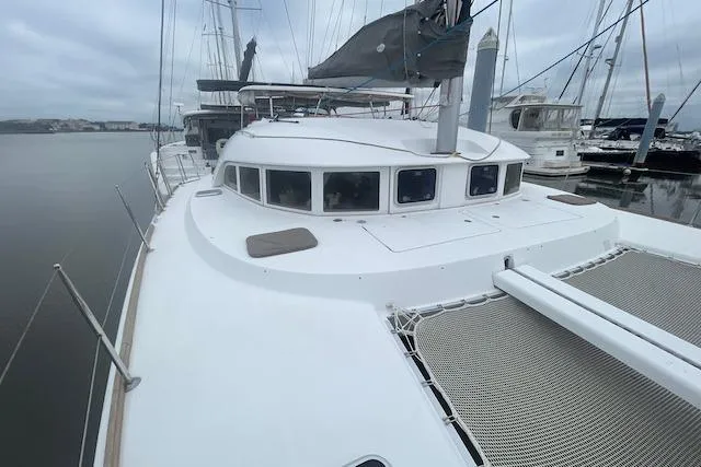 Buzio Yacht Photos Pics 2014 Lagoon 380 S2 catamaran docked at marina, showcasing spacious deck and sleek design.