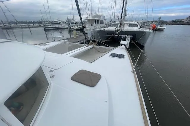 Buzio Yacht Photos Pics 2014 Lagoon 380 S2 catamaran docked at marina, overcast sky.