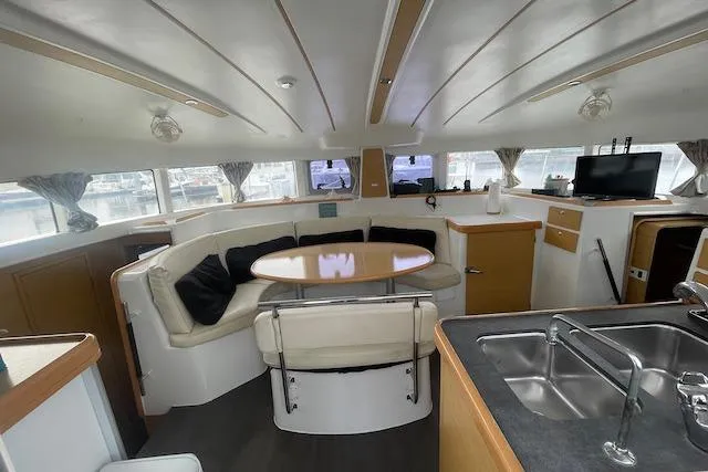 Buzio Yacht Photos Pics Interior of 2014 Lagoon 380 S2 catamaran with modern seating and kitchen area.