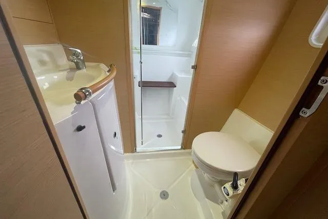 Buzio Yacht Photos Pics 2014 Lagoon 380 S2 yacht bathroom with sink, toilet, and shower.