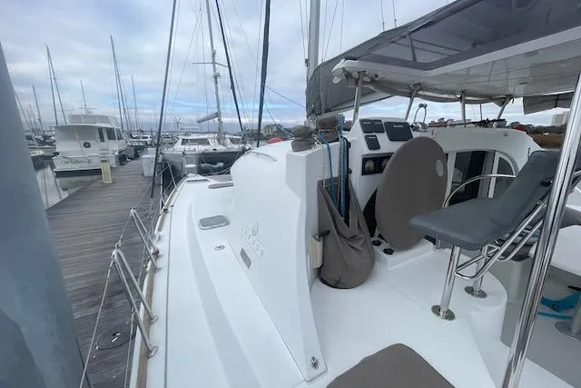 Buzio Yacht Photos Pics 2014 Lagoon 380 S2 catamaran docked at marina, showcasing deck and seating area.