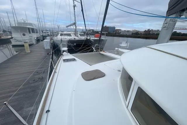 Buzio Yacht Photos Pics 2014 Lagoon 380 S2 catamaran docked at marina, overcast sky.