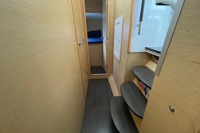 Buzio Yacht Photos Pics Interior of 2014 Lagoon 380 S2 catamaran, featuring wooden paneling and compact cabin space.