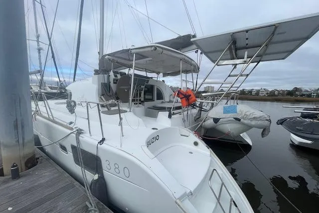 Buzio Yacht Photos Pics 2014 Lagoon 380 S2 catamaran docked, featuring spacious deck and modern design.