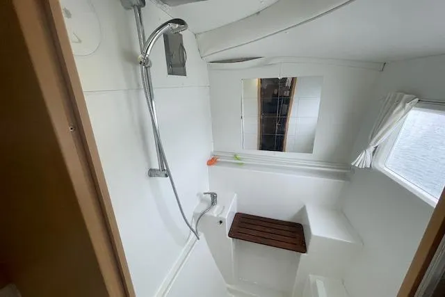 Buzio Yacht Photos Pics Bathroom interior of 2014 Lagoon 380 S2 catamaran with shower and wooden seat.