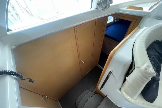 Buzio Yacht Photos Pics Interior view of 2014 Lagoon 380 S2 catamaran cabin with wooden doors and seating.