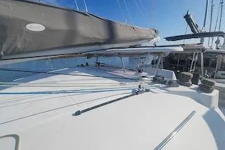 Buzio Yacht Photos Pics 2014 Lagoon 380 S2 catamaran deck with sails and rigging under clear blue sky.
