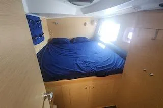 Buzio Yacht Photos Pics Cozy cabin interior of 2014 Lagoon 380 S2 with blue bedding and natural light.