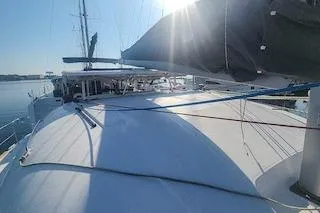 Buzio Yacht Photos Pics 2014 Lagoon 380 S2 catamaran on calm water, sunlit deck view.
