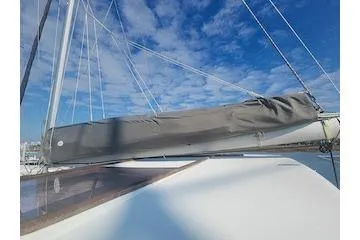 Buzio Yacht Photos Pics 2014 Lagoon 380 S2 sailboat with covered sail under a clear blue sky.