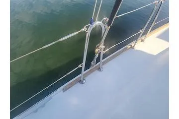 Buzio Yacht Photos Pics Deck view of 2014 Lagoon 380 S2 catamaran with railing over calm water.