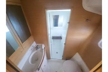 Buzio Yacht Photos Pics 2014 Lagoon 380 S2 yacht bathroom with shower, sink, and toilet.