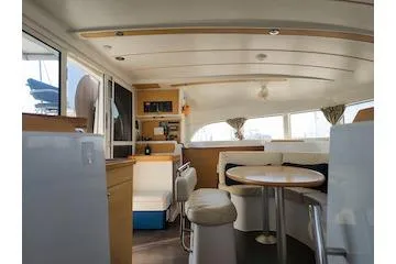 Buzio Yacht Photos Pics Interior of 2014 Lagoon 380 S2 catamaran with modern seating and dining area.