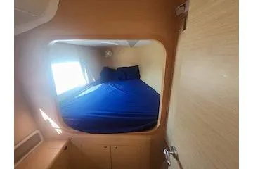 Buzio Yacht Photos Pics 2014 Lagoon 380 S2 cabin interior with blue bedding and wooden finish.