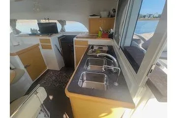 Buzio Yacht Photos Pics Interior of 2014 Lagoon 380 S2 yacht with modern kitchen and scenic window view.