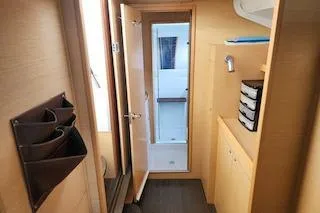 Buzio Yacht Photos Pics Interior of 2014 Lagoon 380 S2 yacht, featuring wooden cabinetry and modern design.