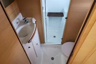 Buzio Yacht Photos Pics 2014 Lagoon 380 S2 yacht bathroom with sink, shower, and toilet.