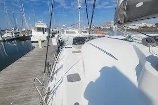 Buzio Yacht Photos Pics 2014 Lagoon 380 S2 catamaran docked at marina under clear blue sky.