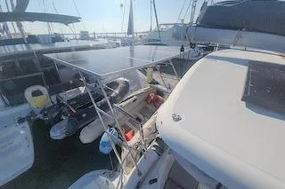 Buzio Yacht Photos Pics 2014 Lagoon 380 S2 catamaran docked with solar panels and dinghy.