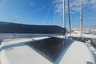 Buzio Yacht Photos Pics 2014 Lagoon 380 S2 catamaran with solar panel, docked in a marina under clear blue skies.