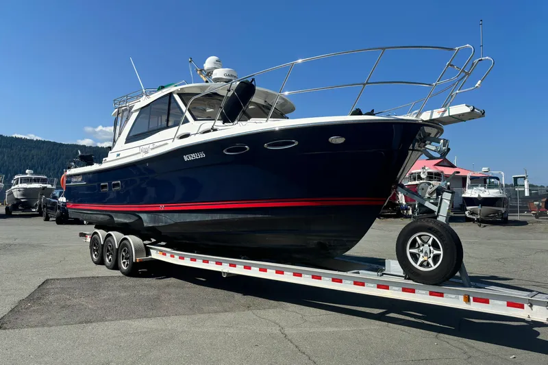  Yacht Photos Pics 2017 Cutwater C-302 Sport Coupe on trailer, parked outdoors under clear blue sky.