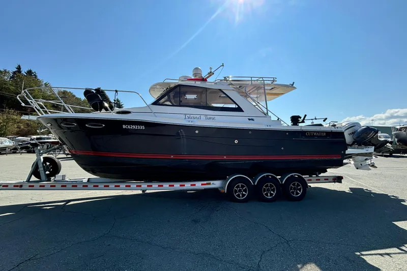  Yacht Photos Pics 2017 Cutwater C-302 Sport Coupe boat on trailer under clear blue sky.